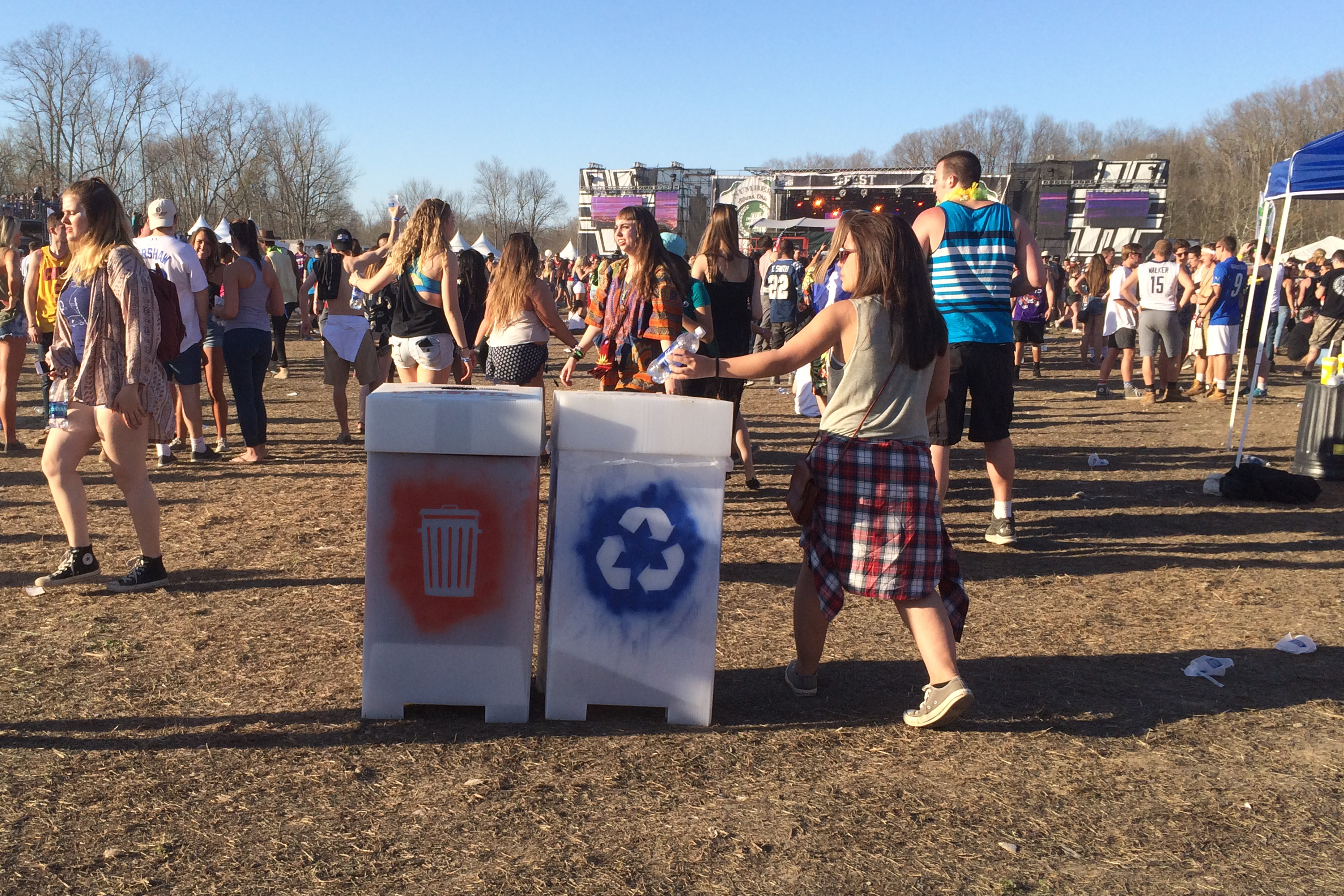 A young woman recycles her water bottle at #Fest 2016.