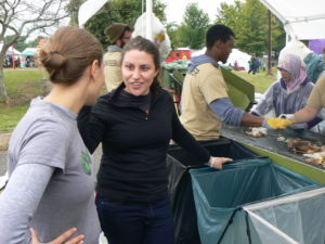 A Zero Waste Event Productions volunteer talks to a festival attendee about zero waste at The Ohio Pawpaw festival.