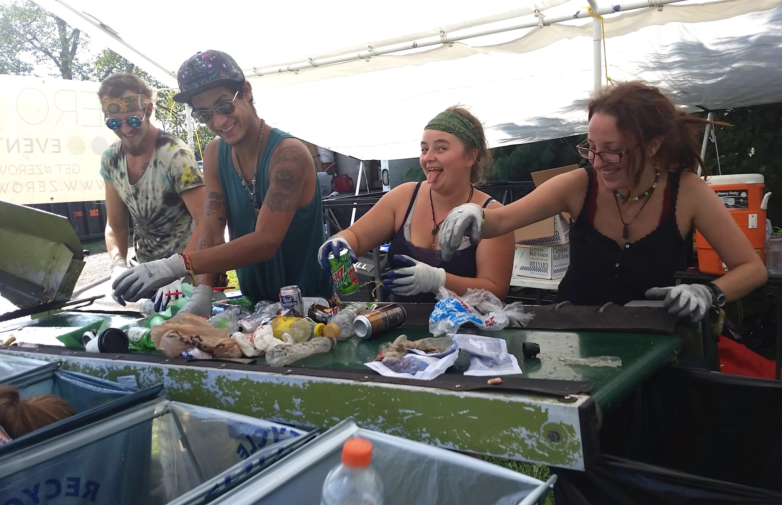 Zero Waste Event Productions volunteers sort recycling and compost on a mobile conveyor belt during Resonance Music Festival.